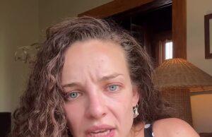 News Room : Abbie Chatfield commits major wardrobe faux pas in Instagram video: ‘I’m so embarrassed’ Upset woman with curly hair and blue eyes in a polka dot dress, indoors, emotional expression.