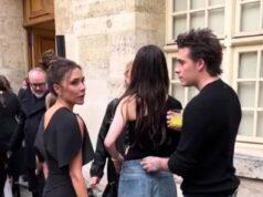 Discussions among stylish young adults at an outdoor event in a historic city setting.