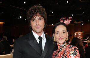 News Room : Awkward moment Jacob Elordi’s mother snubs Leonardo DiCaprio backstage at the Golden Globes Elegant woman in a vibrant patterned dress standing next to man in a sharp black suit at a formal event.
