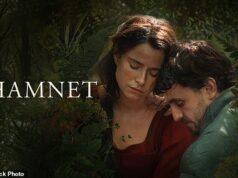 Two actors in a lush garden setting for the production "Hamnet" with a contemplative mood.