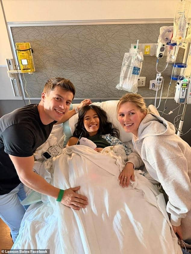 News Room : Bringing Up Bates alum Lawson Bates says Young girl in hospital bed with two smiling visitors, medical equipment in background.