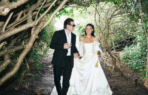 News Room : Brooklyn Beckham’s explosive claim his mother Victoria pulled out of designing Nicola Peltz’s wedding dress at the ‘eleventh hour’ is contradicted by bride’s stylist who said her couture Valentino gown took a YEAR to make Stylish couple walking through lush garden forest in elegant wedding attire, enjoying a romantic moment.