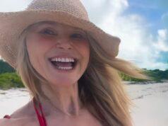Bright smiling woman in sun hat at beach, enjoying a sunny day in Sri Lanka.