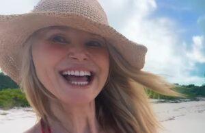 Bright smiling woman in sun hat at beach, enjoying a sunny day in Sri Lanka.