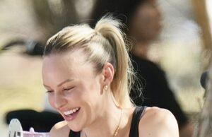 News Room : Jules’ new start: We track down Lachie Neale’s heartbroken wife in Perth after she packed up her life in Brisbane following her husband’s betrayal Smiling woman enjoying a meal at an outdoor cafe, wearing black top and gold jewelry.
