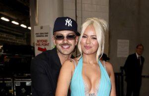 News Room : Karol G and boyfriend Feid SPLIT after three years of dating Smiling couple embracing at an indoor event, woman in a striking blue gown with thigh-high slit.