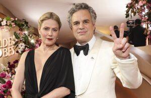 News Room : Mark Ruffalo, Natasha Lyonne and other stars protest Renee Good death with ‘ICE Out’ pin at 2026 Golden Globes Elegant couple at a glamorous event, dressed in formal attire with floral decor in the background.