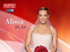 Elegant bride Alissa in wedding dress holding a bouquet of red roses at Sri Lanka news event.