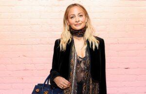 News Room : Nicole Richie addresses her daughter’s new identity after unveiling transformation on her 18th birthday Fashionable woman with blonde hair posing against a pink brick wall, holding a blue handbag.