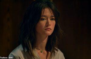 News Room : Revealed: Murder-suicide family secret of Traitors PhD brainbox Jade Scott Young woman with dark wavy hair, contemplative expression, indoor dark background.
