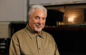 News Room : Sir Tom Jones issues a ‘sad and disheartening’ warning as he begs his fans to be ‘careful and stay safe’ after falling victim to online scams A senior man with white hair and a beard smiling indoors.