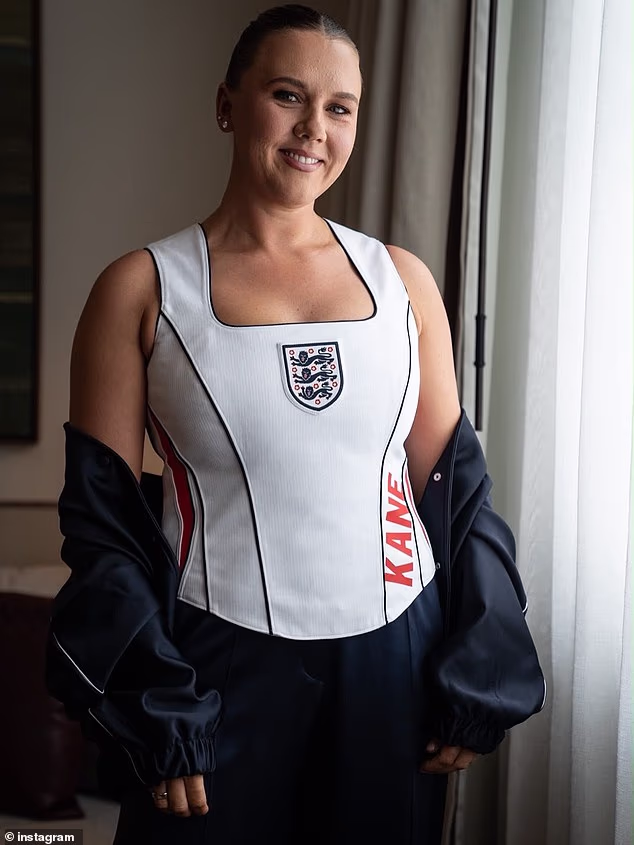 News Room : Kate Kane poses in custom England 'corset'